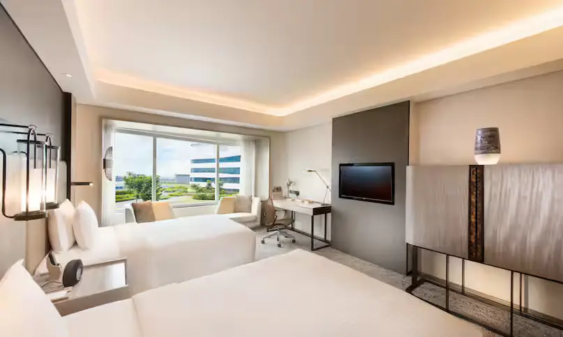 Conrad Manila twin deluxe city view bedroom jpg